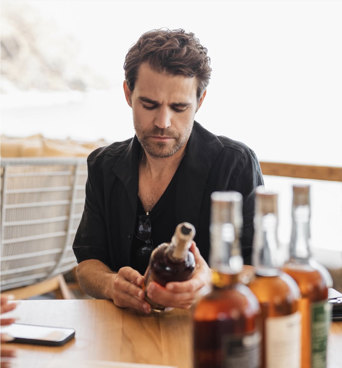 Guest reviewing a bourbon bottle during the tasting
